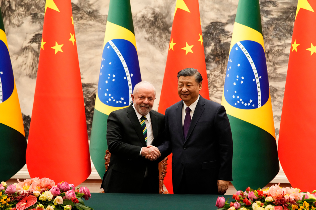 Chinese President Xi Jinping (R) and Brazilian President Luiz Inácio Lula da Silva shake hands in Beijing on April 14